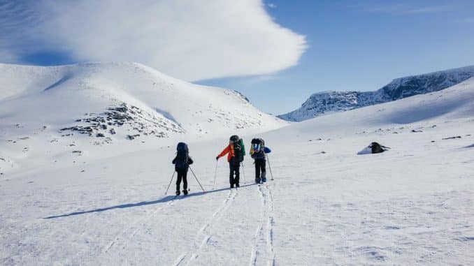 three skiers