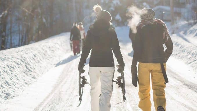 2 skiers walking 2 skiers walking