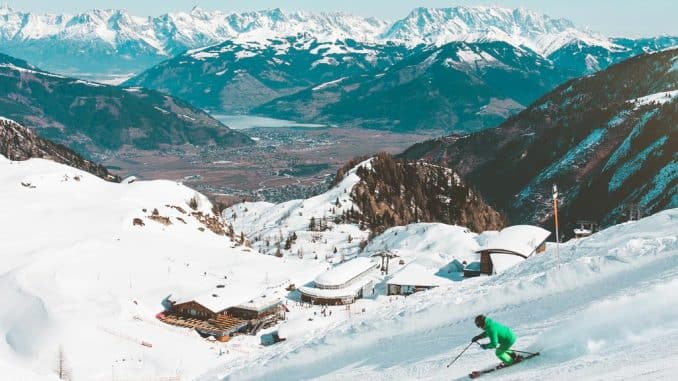 man in green skiing in resort