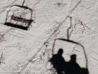 shadow of 2 people on ski lift